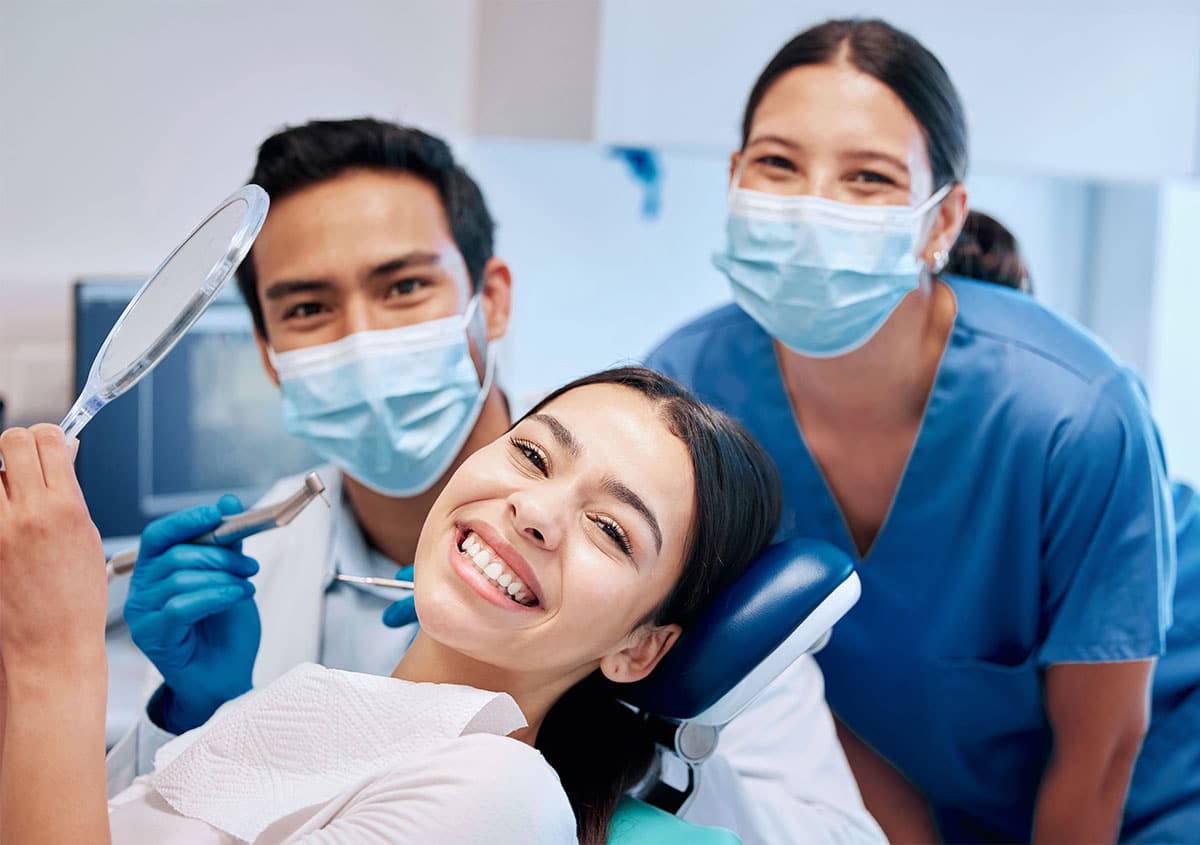 Woman smiling with dentist providing expert dental care near Everett WA