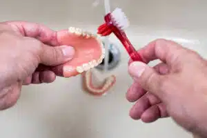 Denture cleaning brush used to clean removable dentures