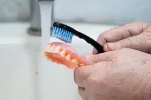 Soft brush for dentures removing plaque from dentures